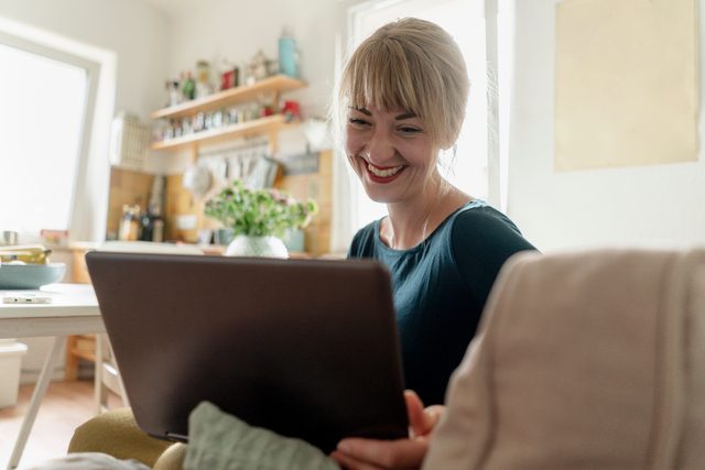 woman on video call with friends and family smiling