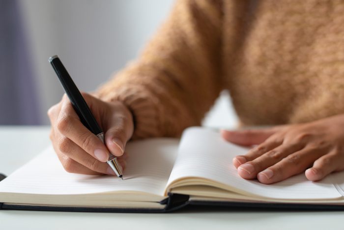 person writing in a journal