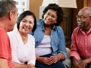 Supportive family talking together inside a home.