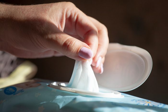 Hand picked a wet wipes in package box, Wet wipes in a woman's hand