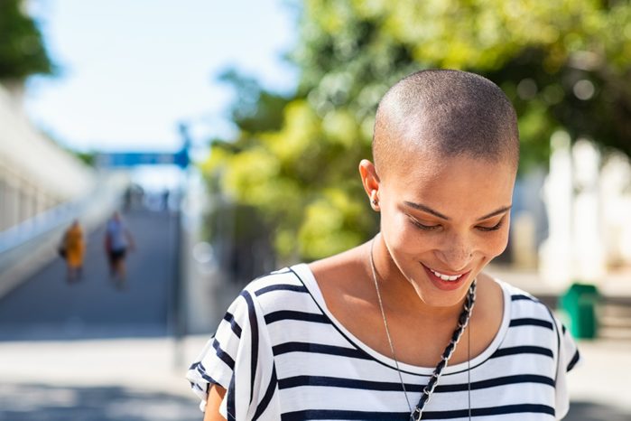 woman smiling and walking outdoors