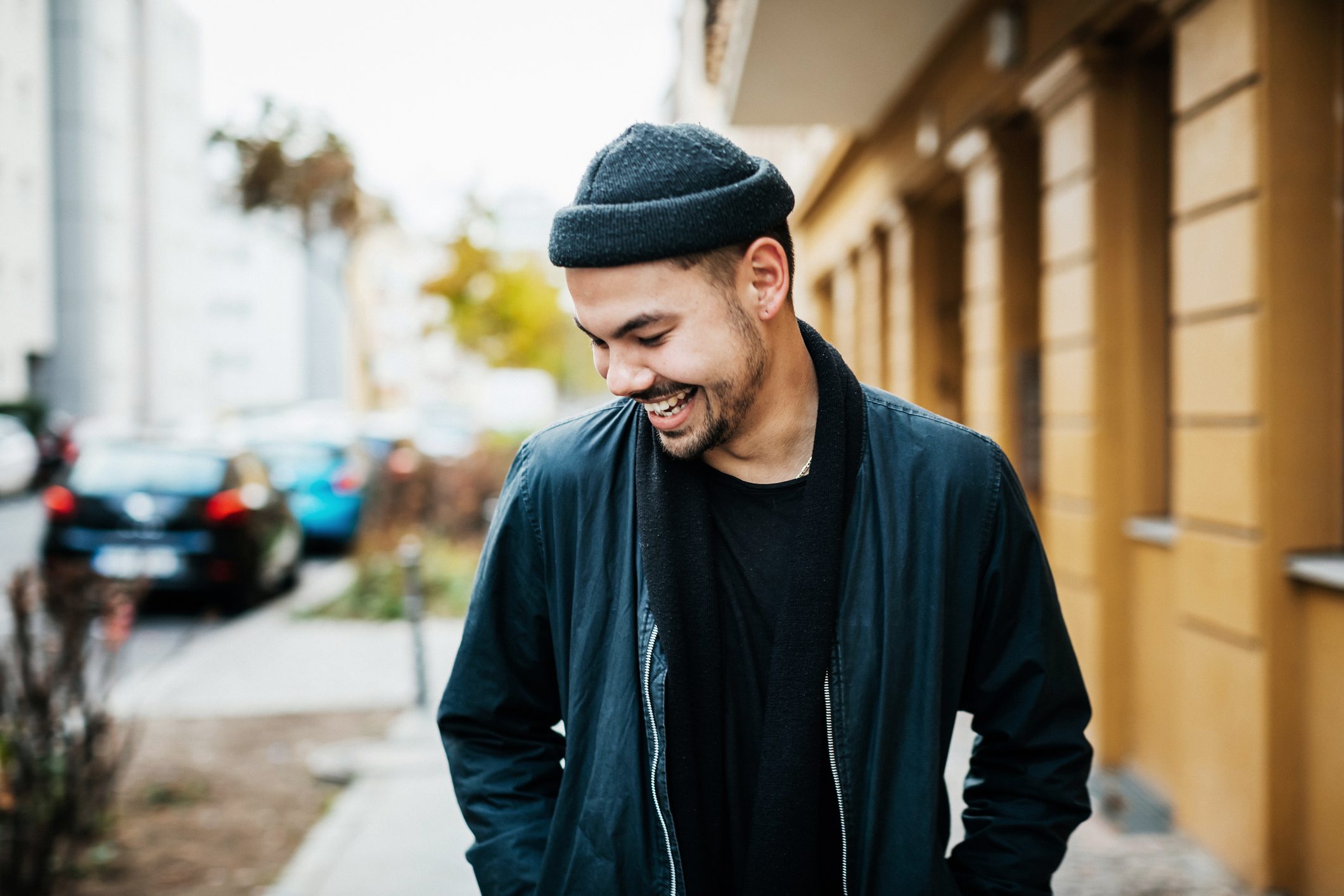 young happy man walking on the street