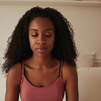 woman meditating in bed