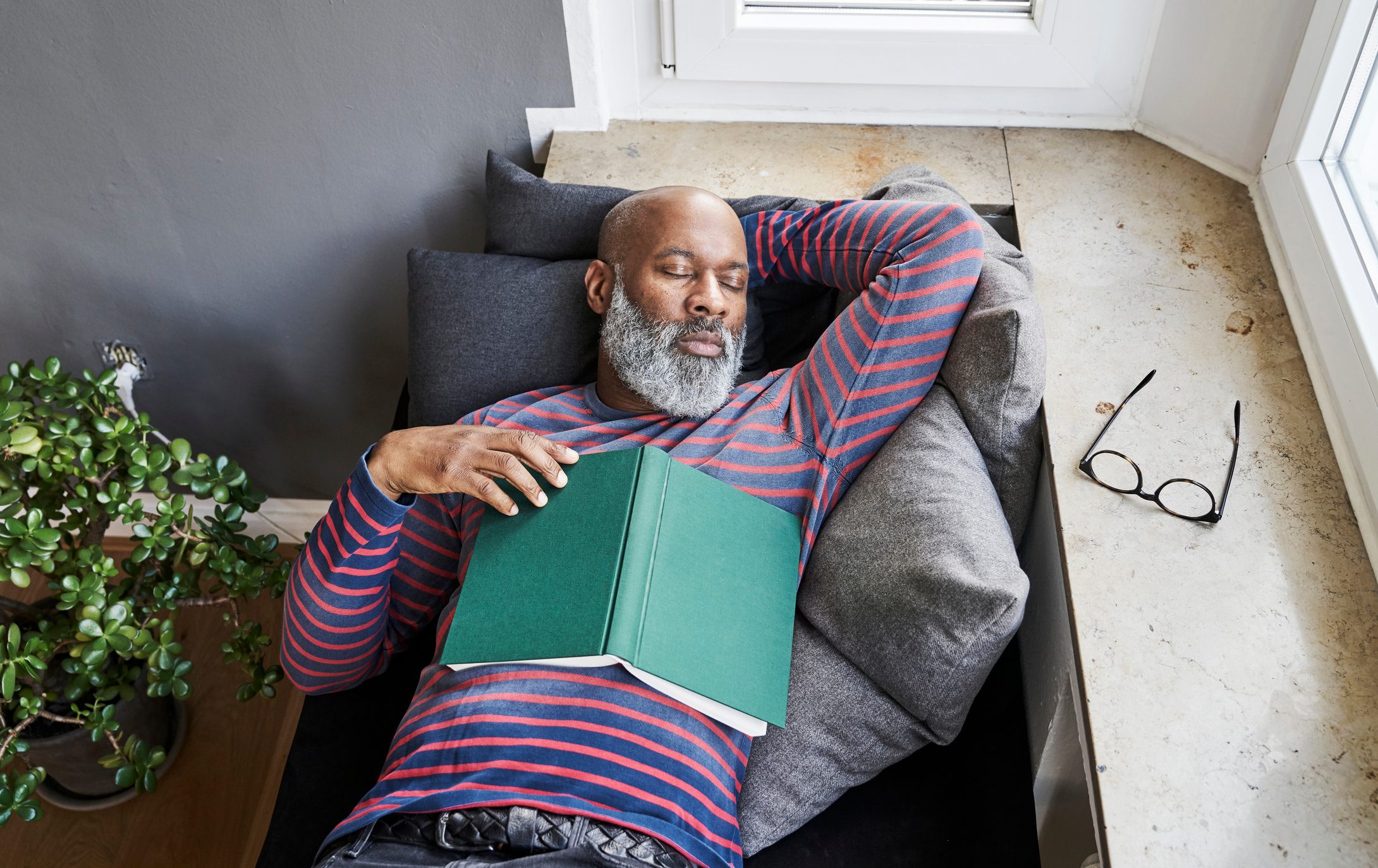 man taking a nap on couch at home
