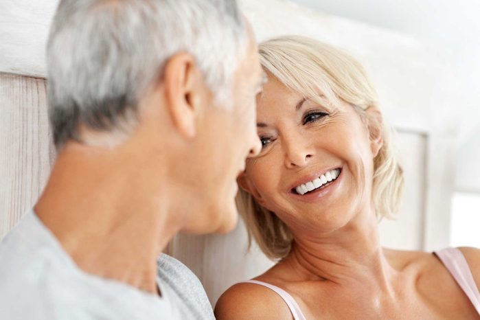 happy older couple in bed