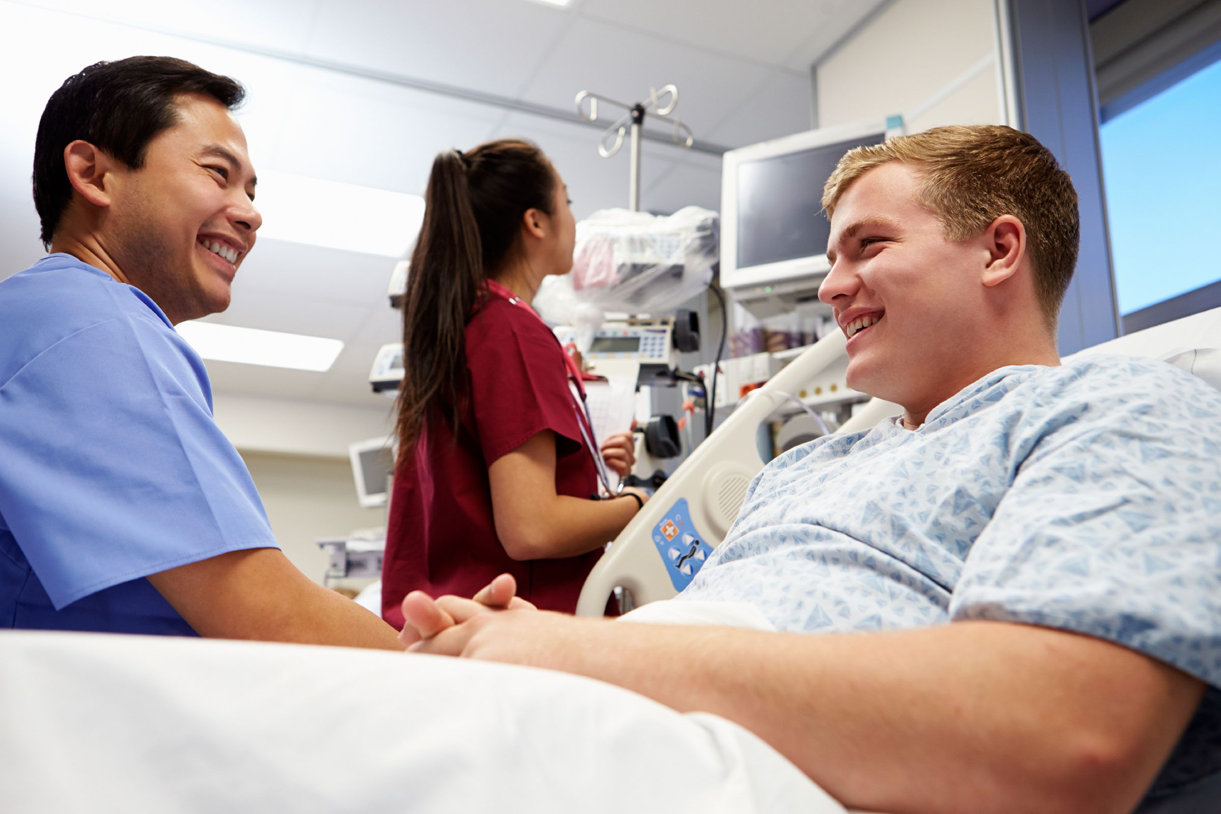 patient in hospital bed talking to doctor