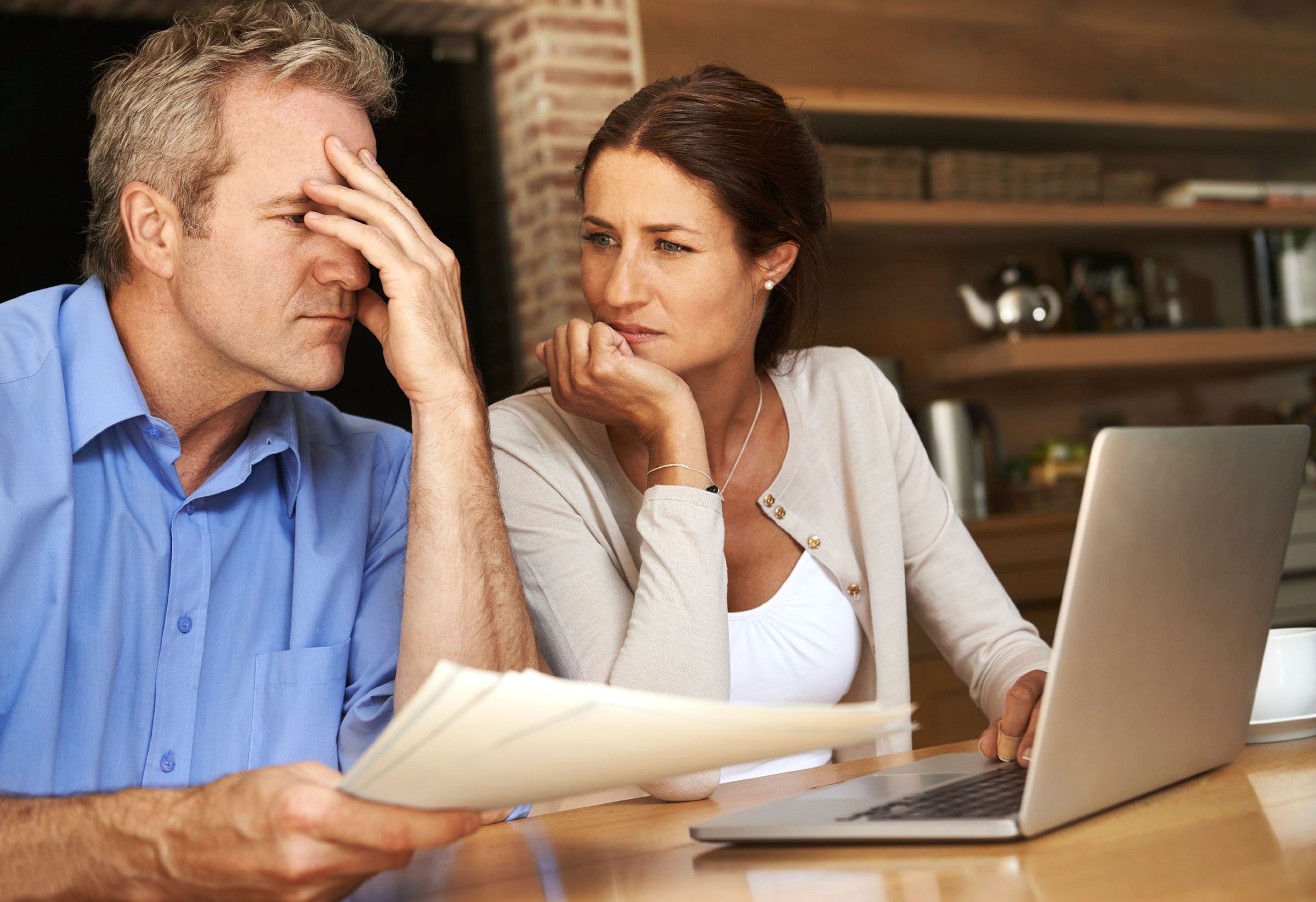 husband and wife discussing medical bill at home