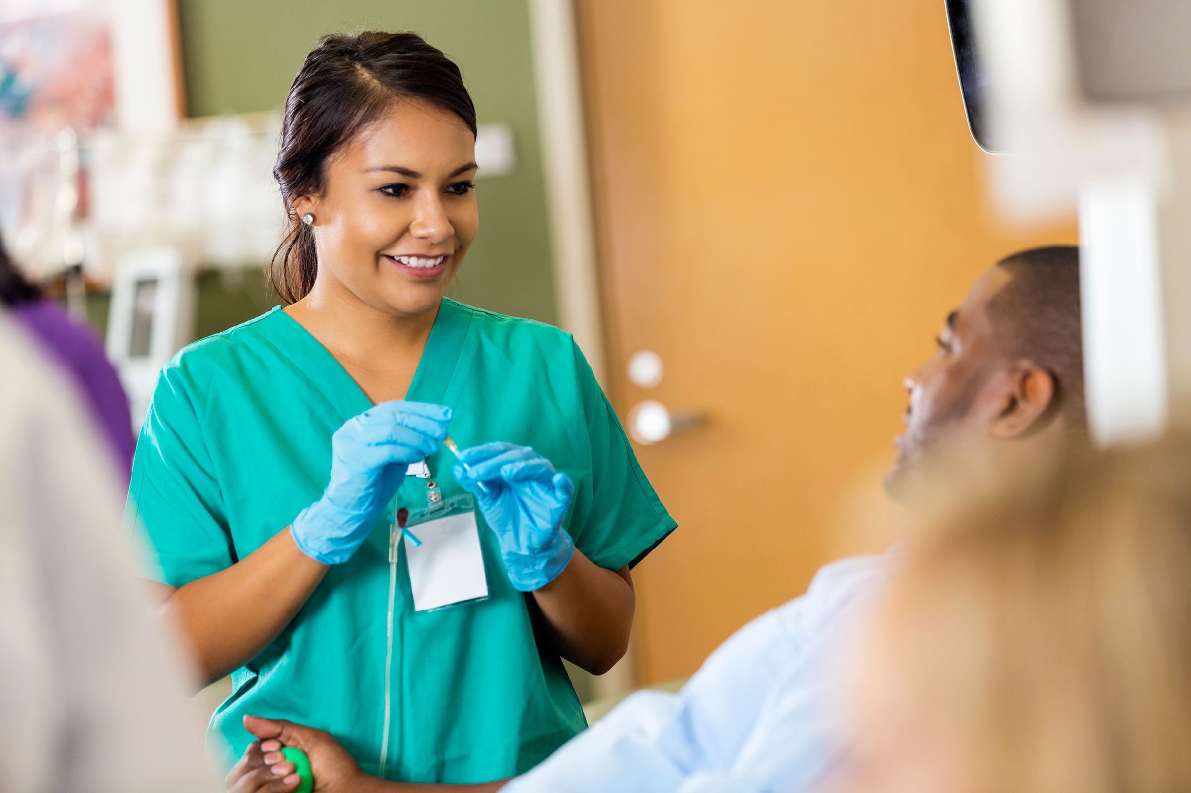 female doctor talking to bed-ridden patient