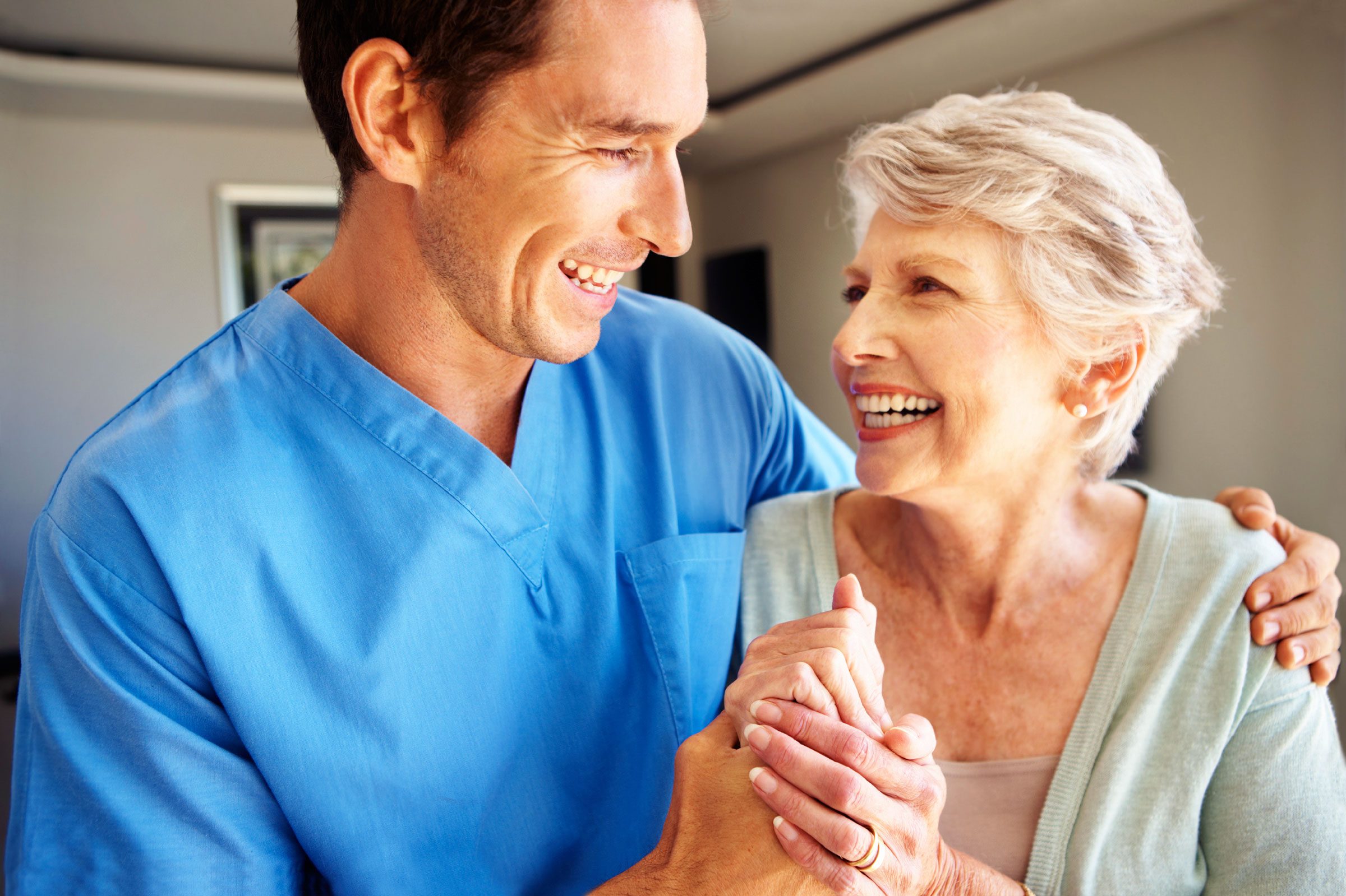 doctor with his arm around an elderly woman