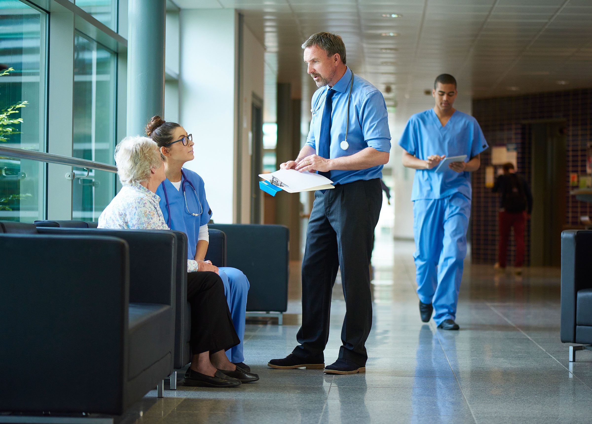 doctors talking to patient in waiting room