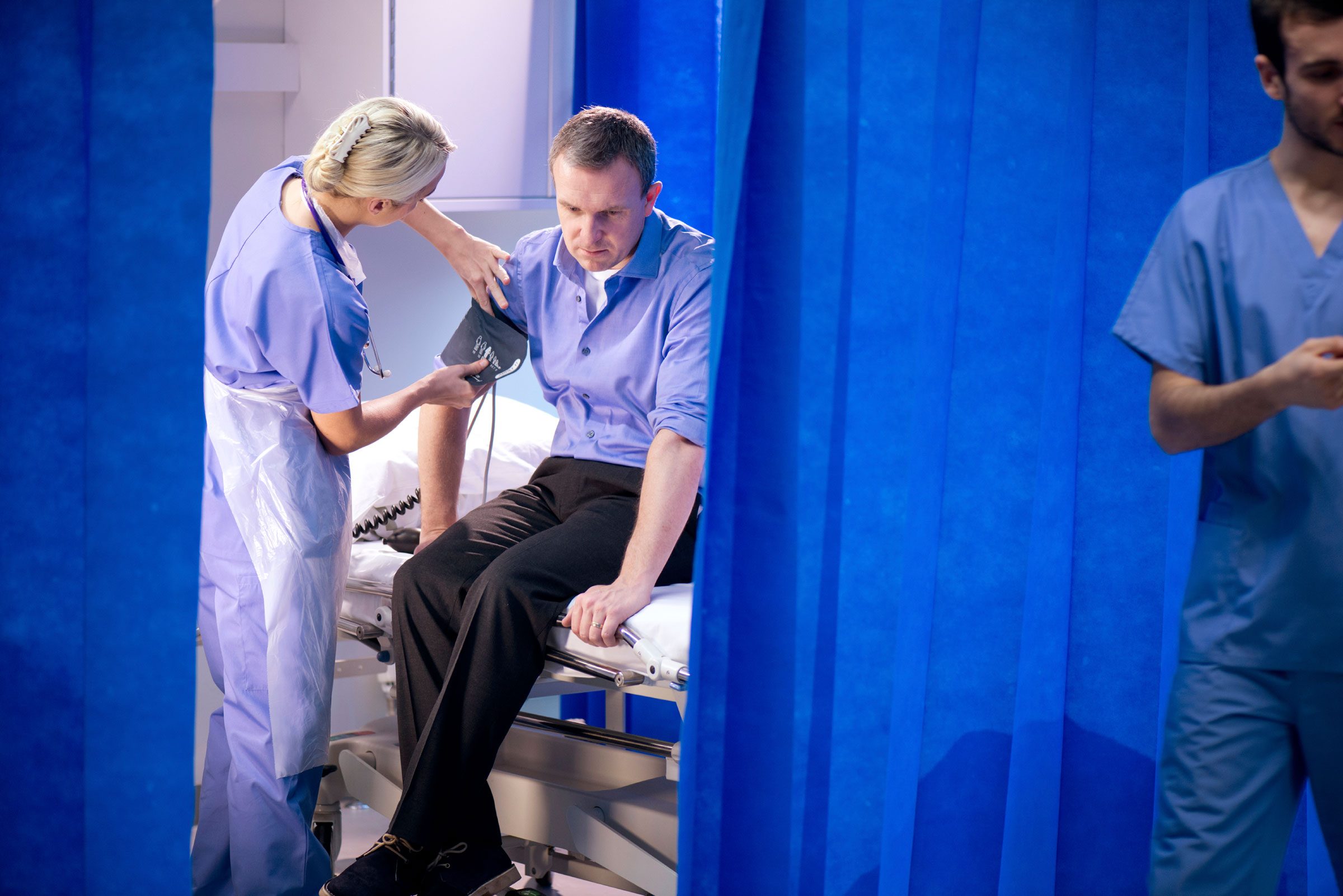 nurse checking a man's blood pressure