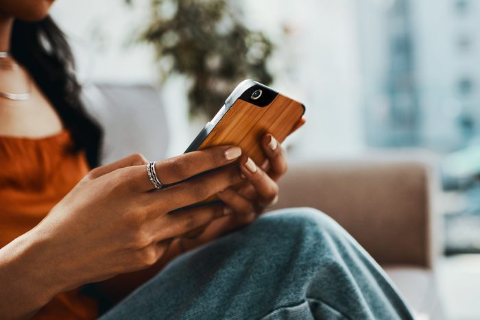 close up of woman holding smartphone