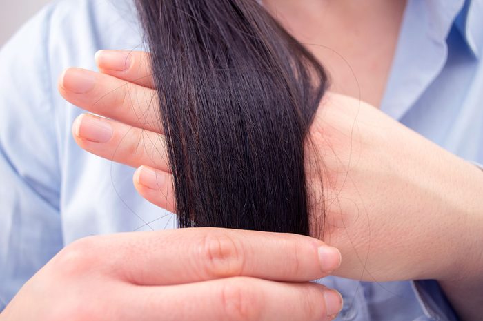 woman holding her long hair