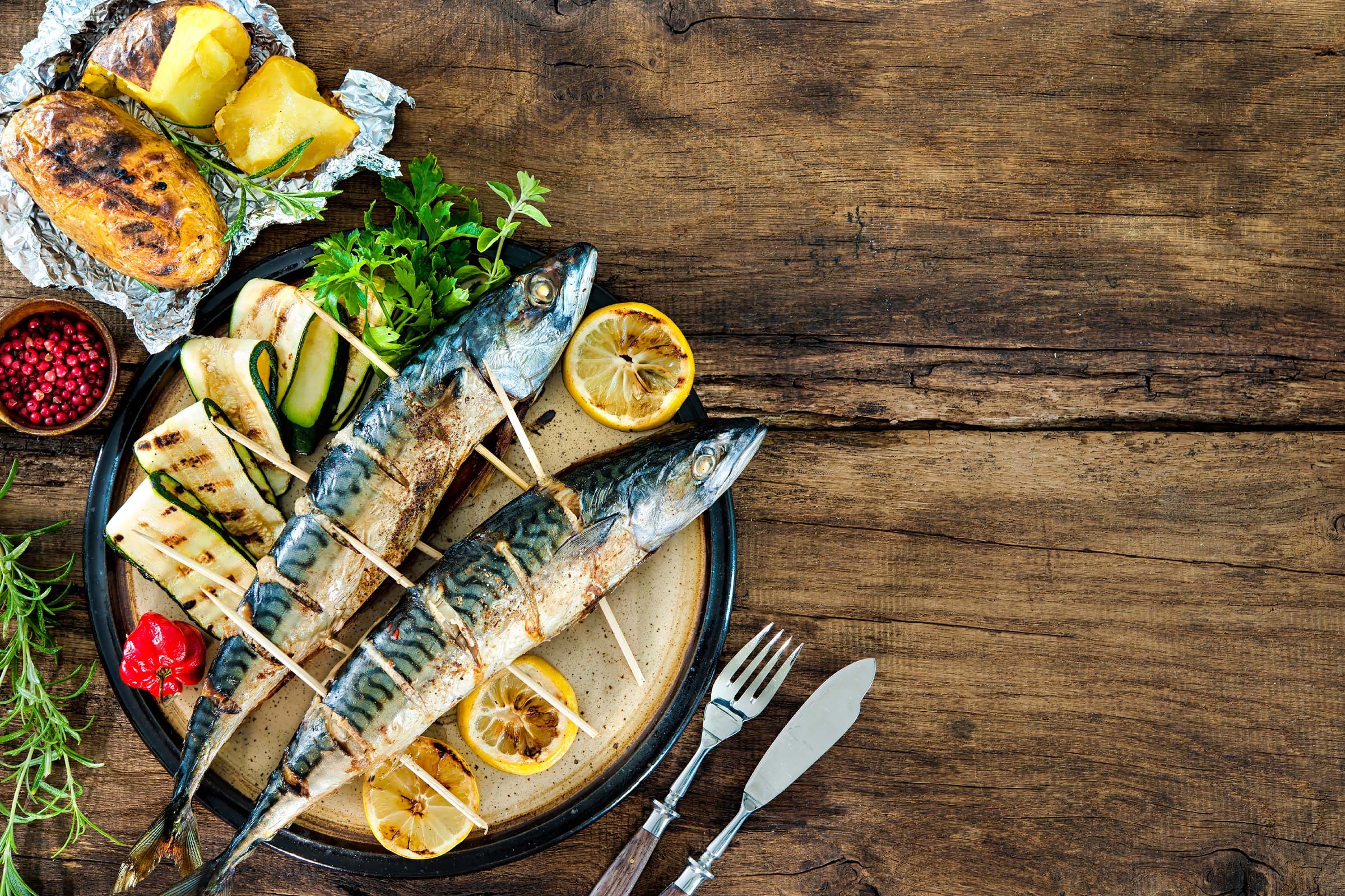 two fresh mackerel fish with vegetables 