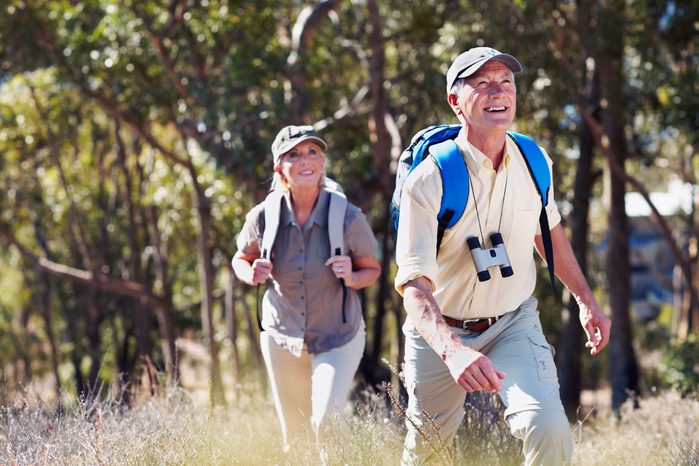 man and woman hiking in the woods