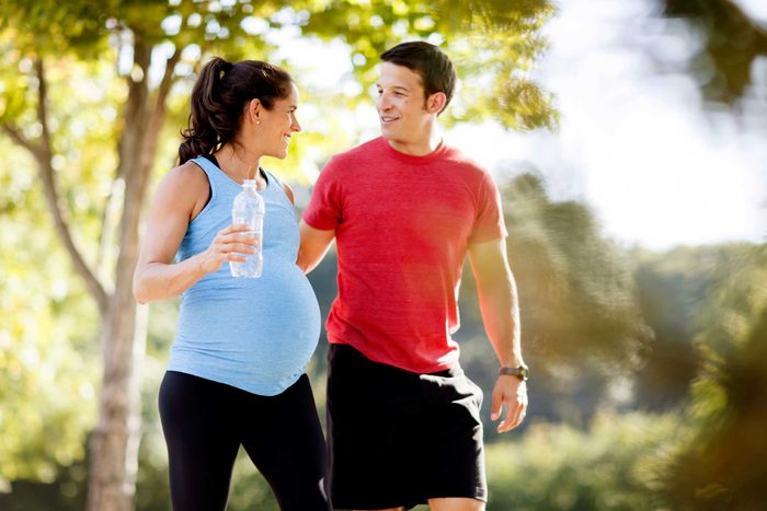 man and pregnant woman walking