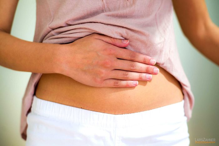 woman with hand on belly