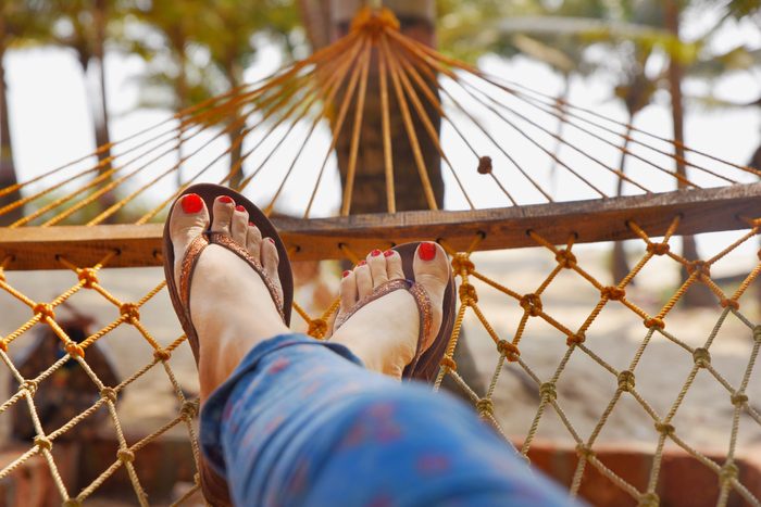 low section of woman resting on a hammock