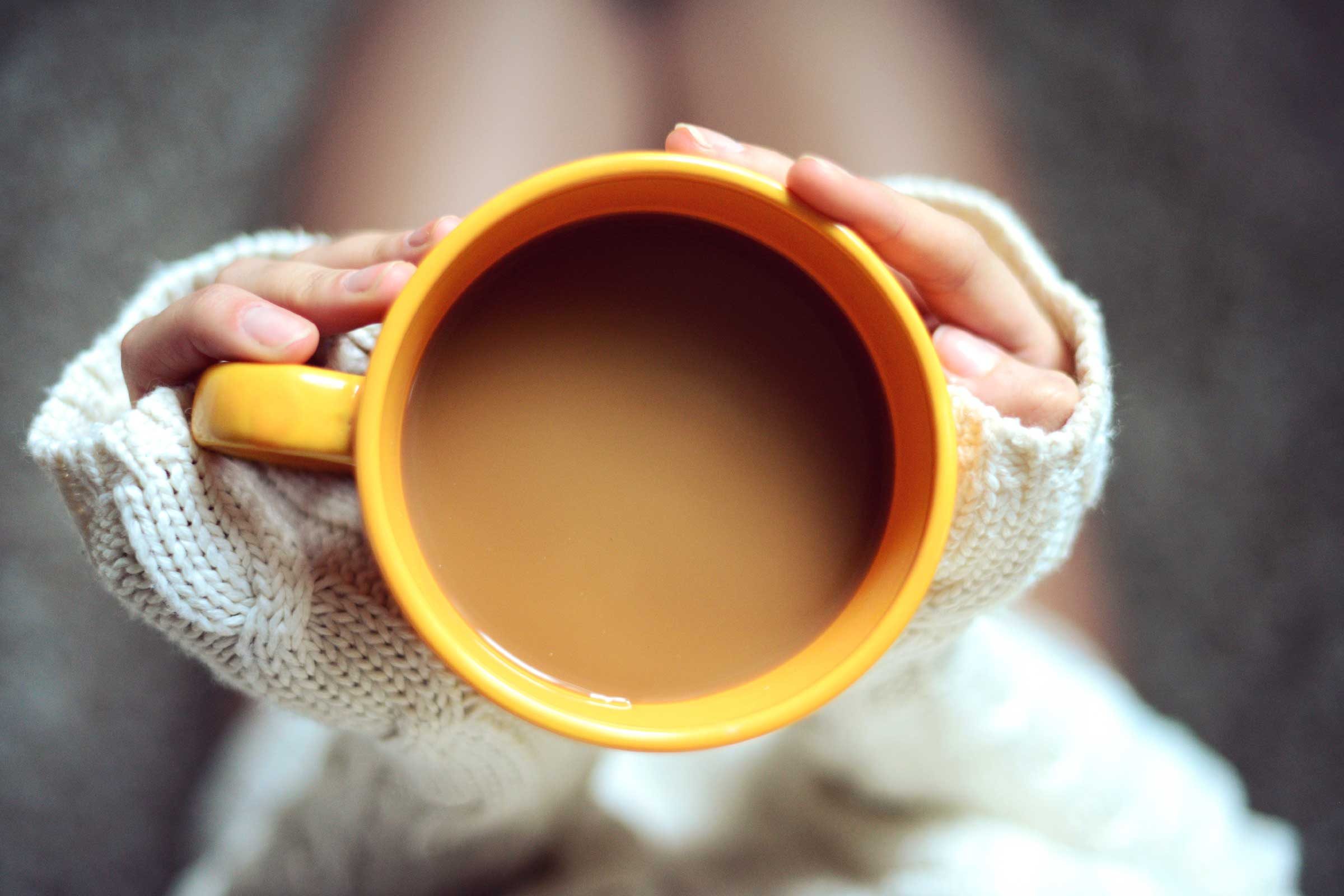 hands holding big cup of coffee