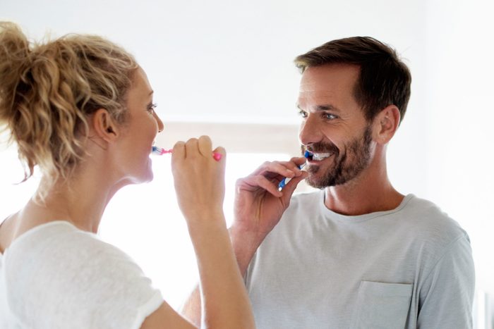 couple brushing teeth
