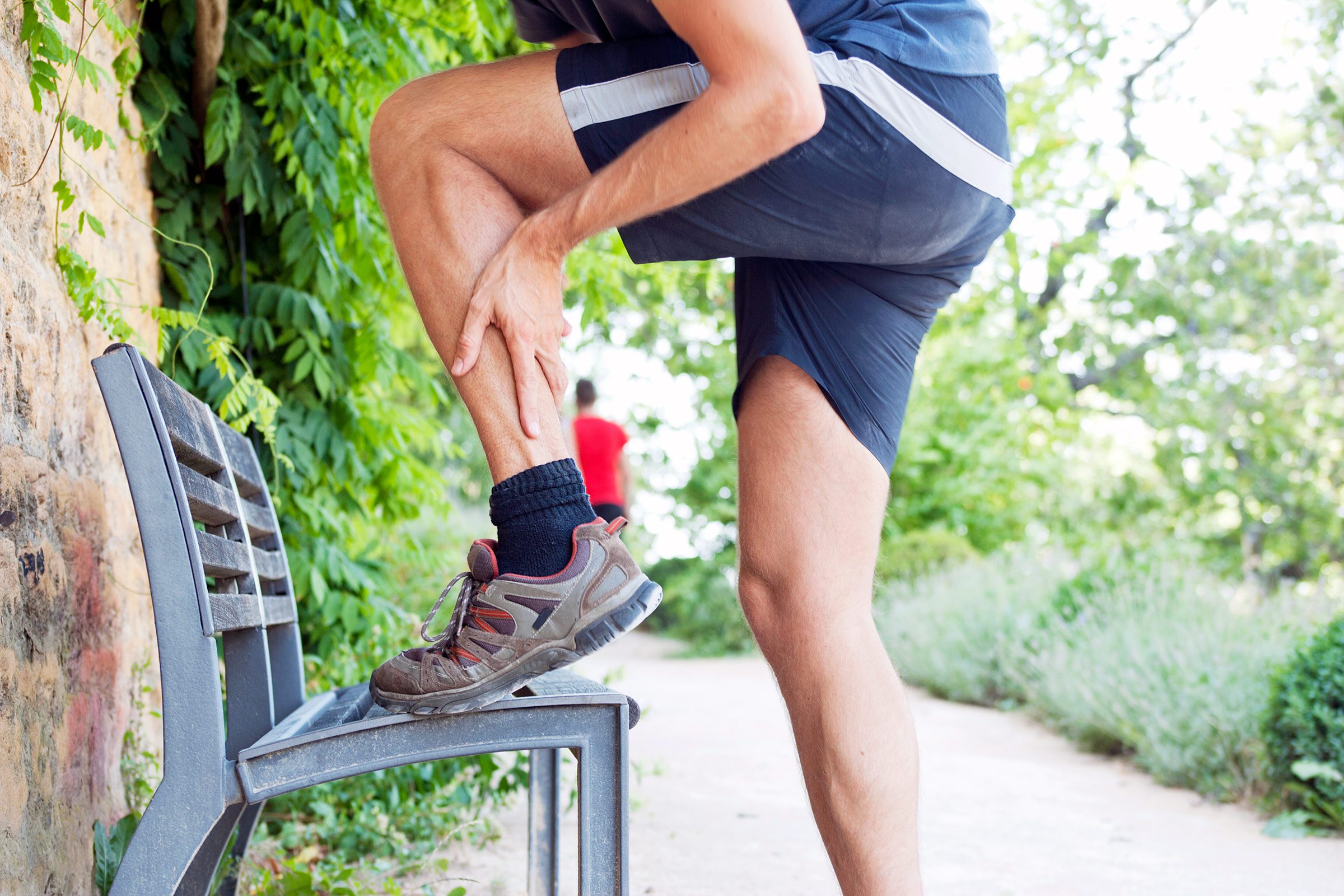 Runner holding lower leg