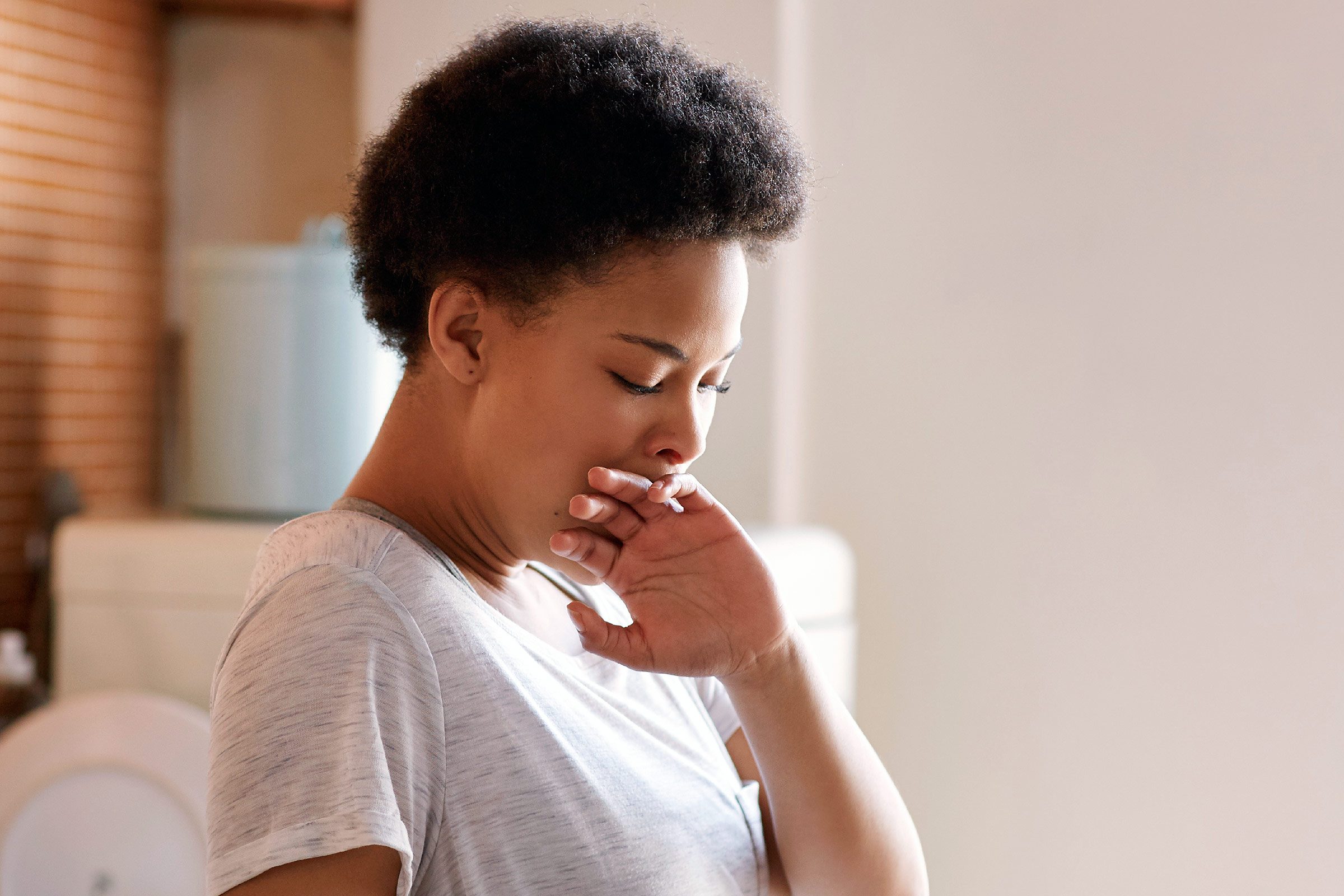 Woman stifling a yawn