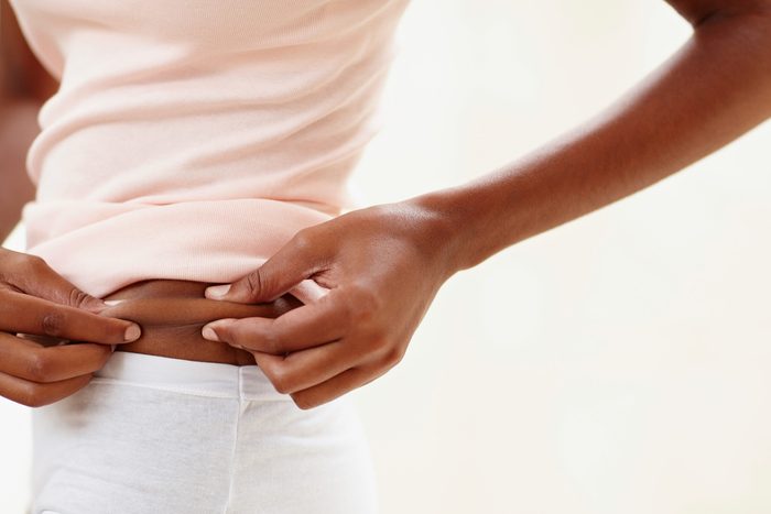 woman pinching her waist