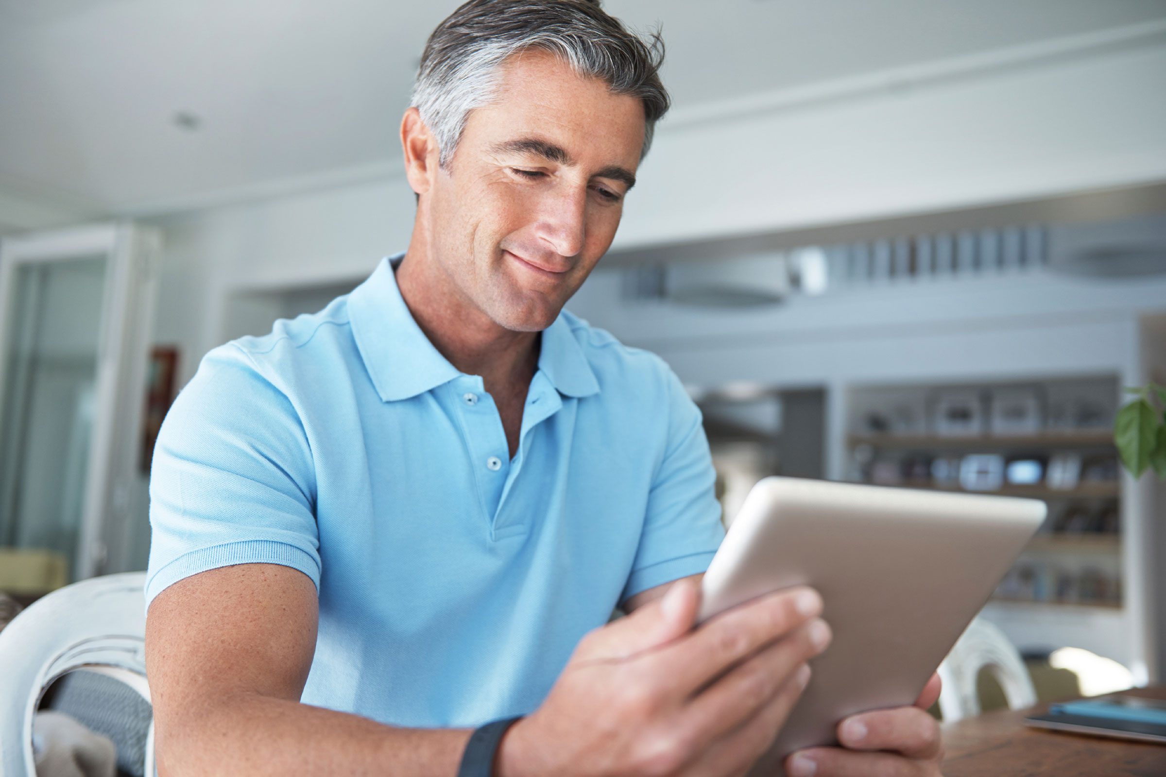 happy man looking at iPad