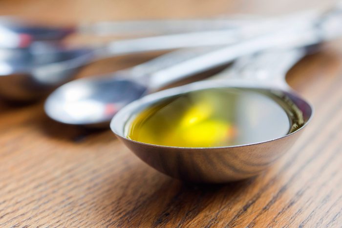 measuring spoons; one filled with liquid