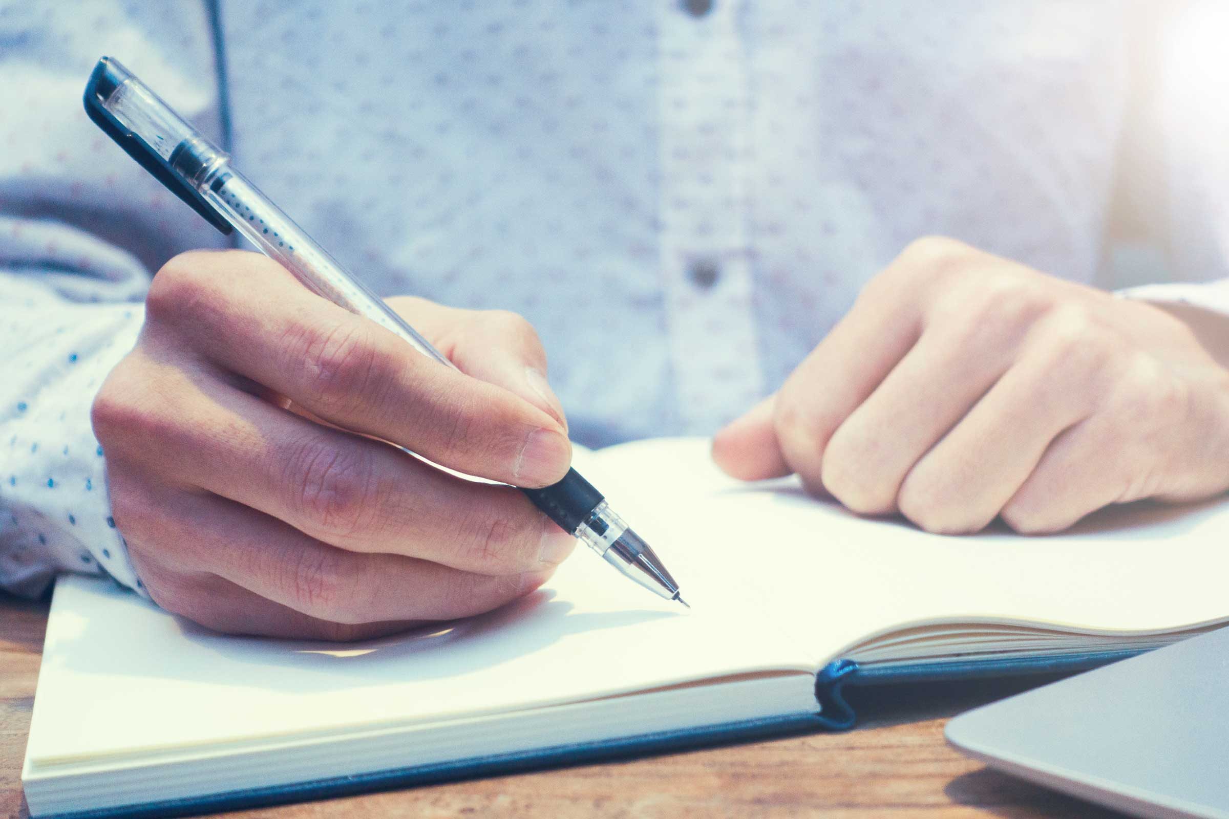 person writing in journal