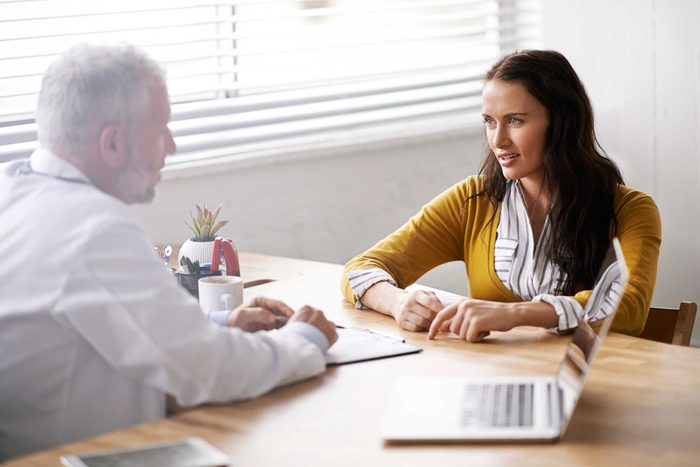 woman in conversation with an gray-haired doctor