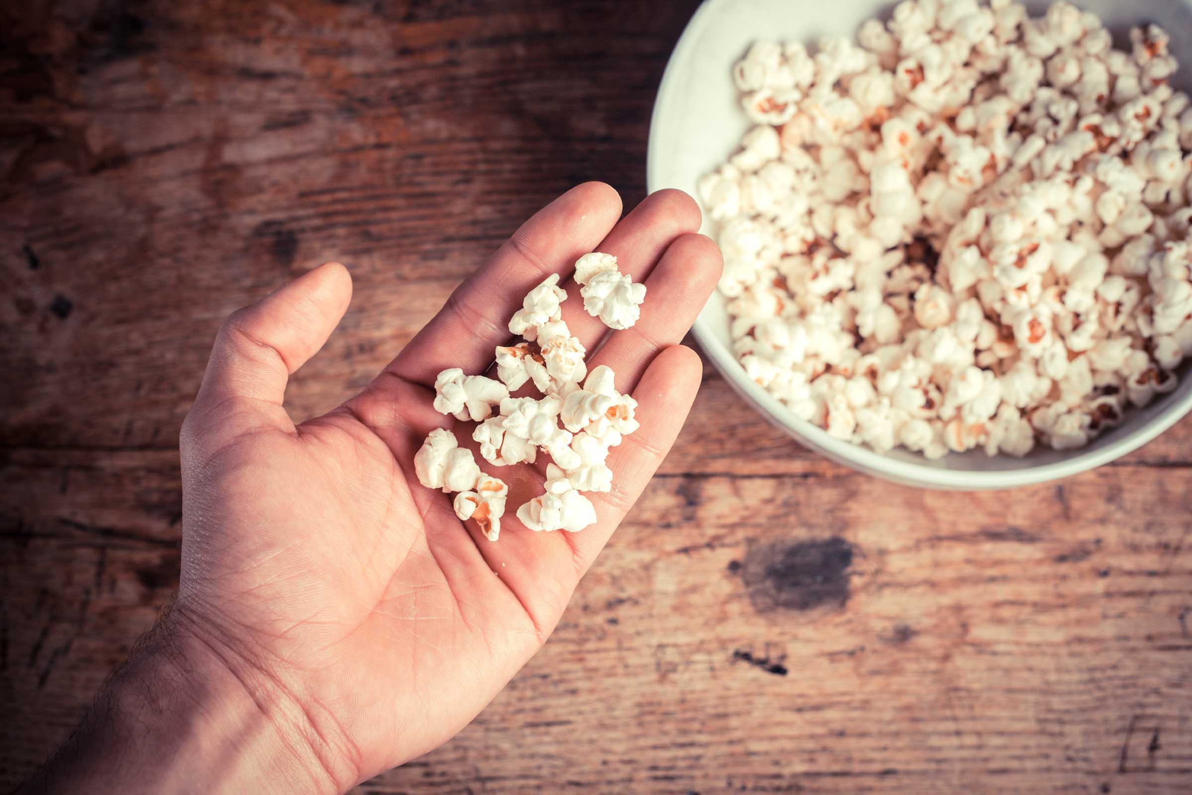 person with bowl of popcorn