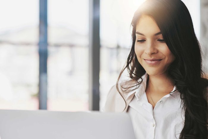 Woman sitting near a window in her office.