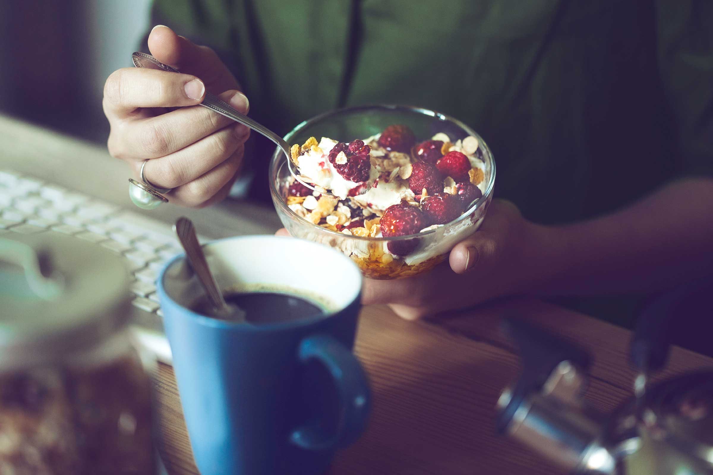 person eating bowl of healthy cereal