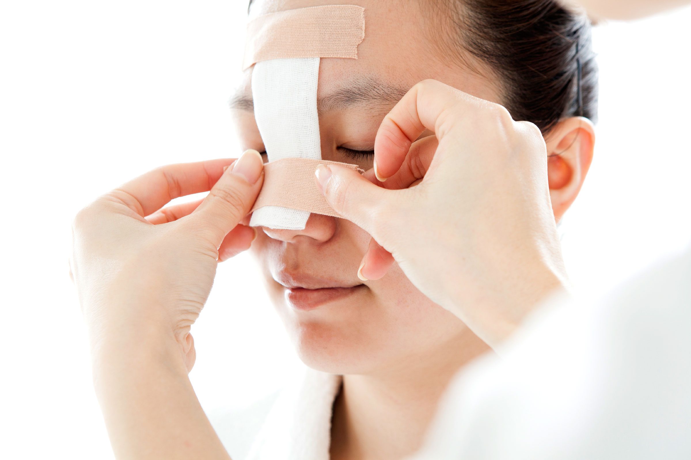 patient getting nose bandaged