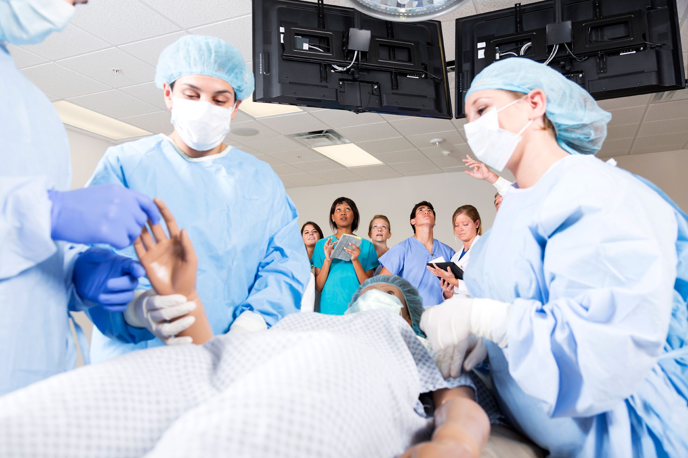 patient on gurney being prepped for surgery by team of people