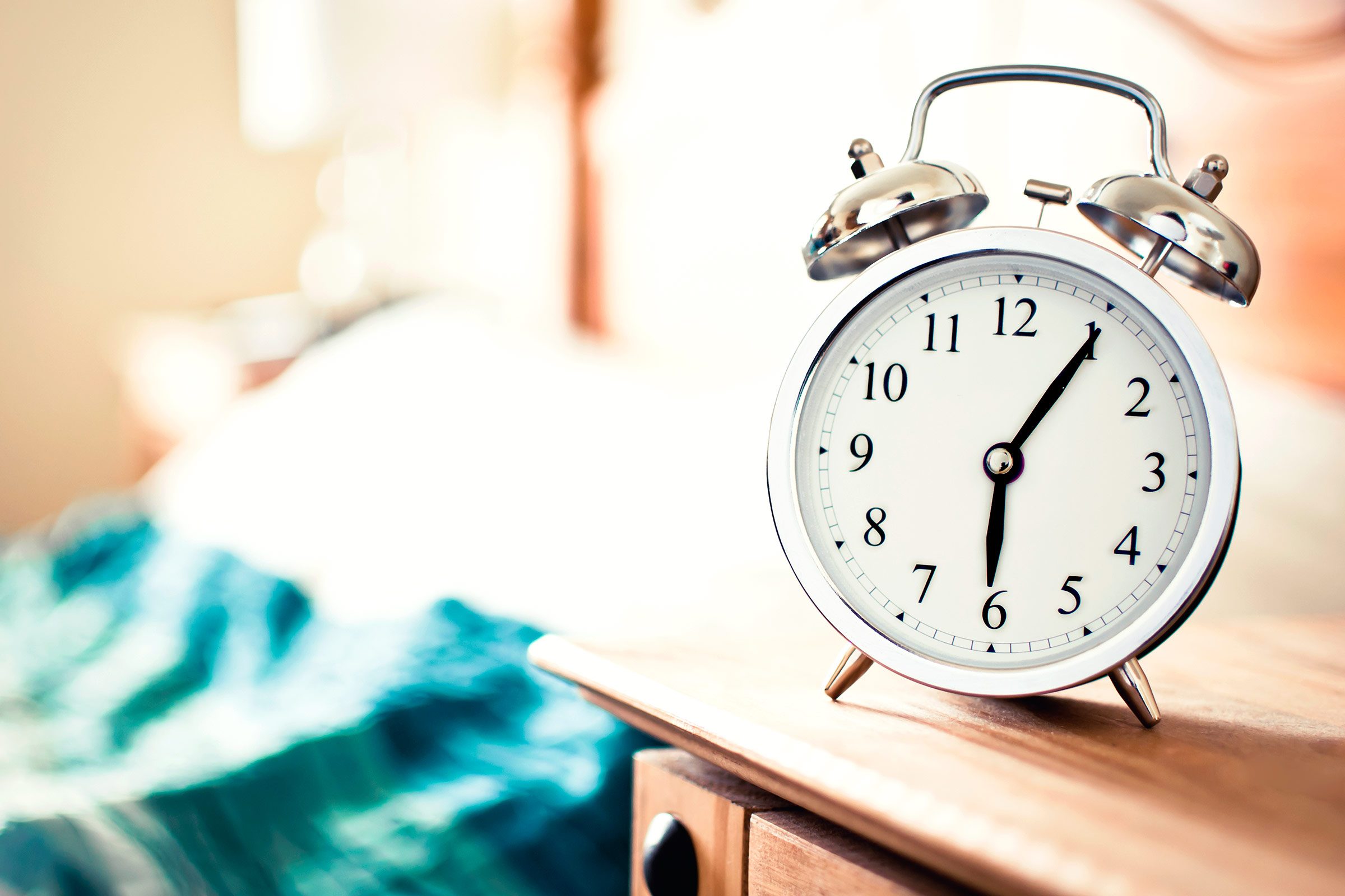 old-style alarm clock on a bedside table 