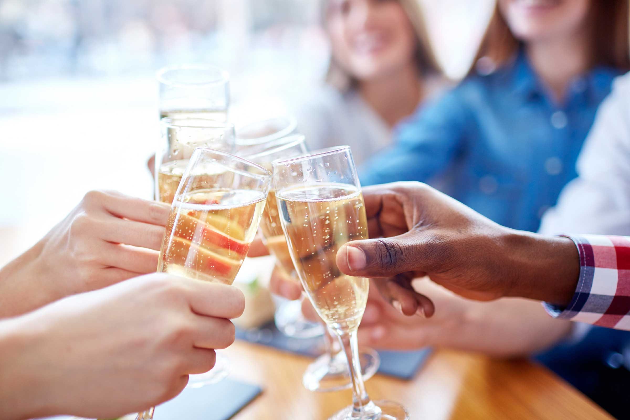 people toasting with flutes of champagne