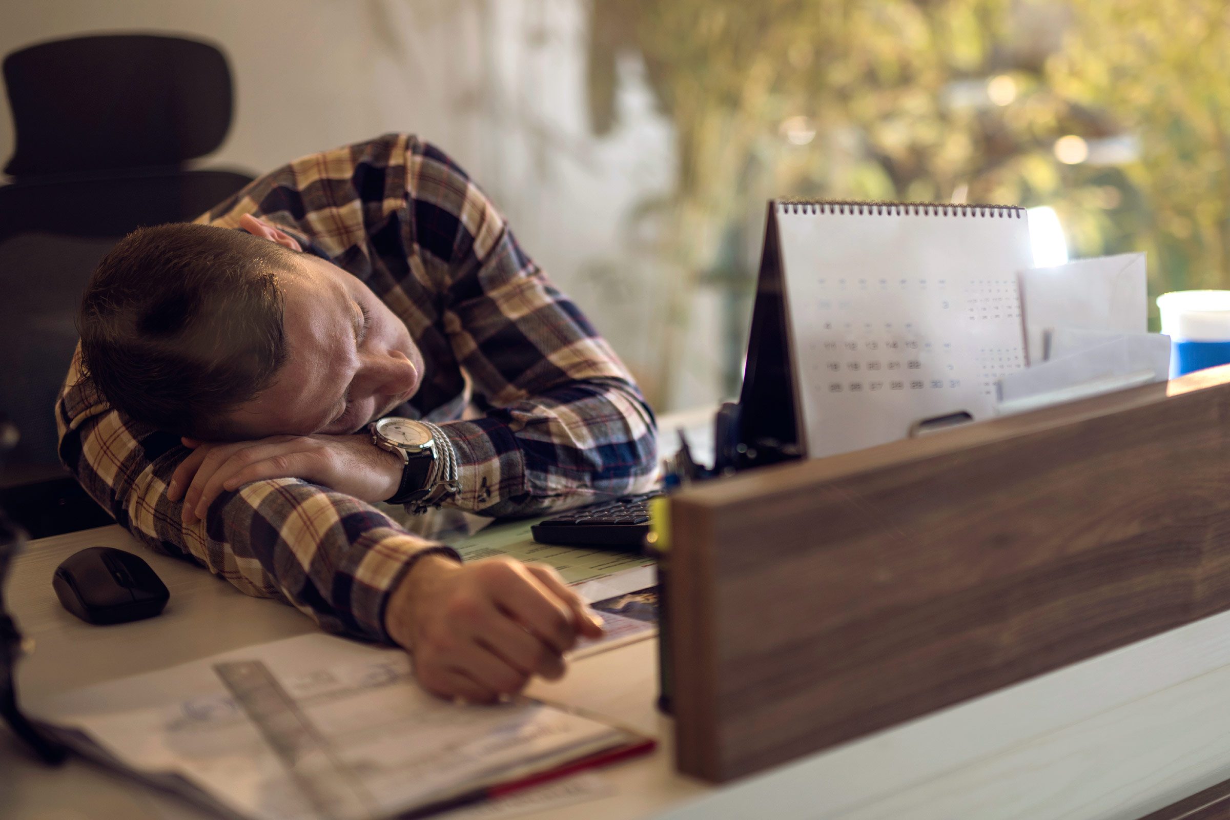 man asleep at his desk