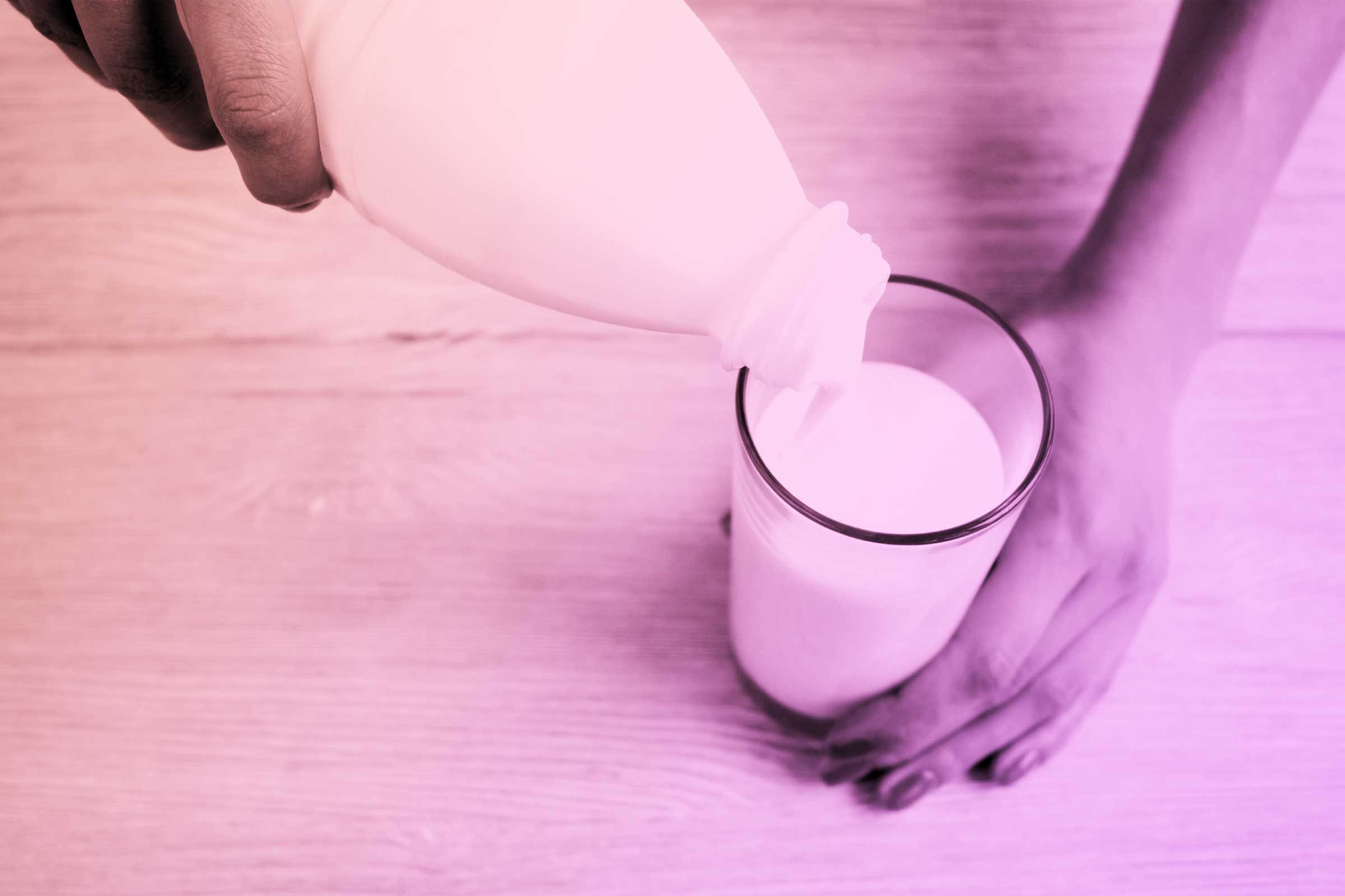 milk being poured in glass