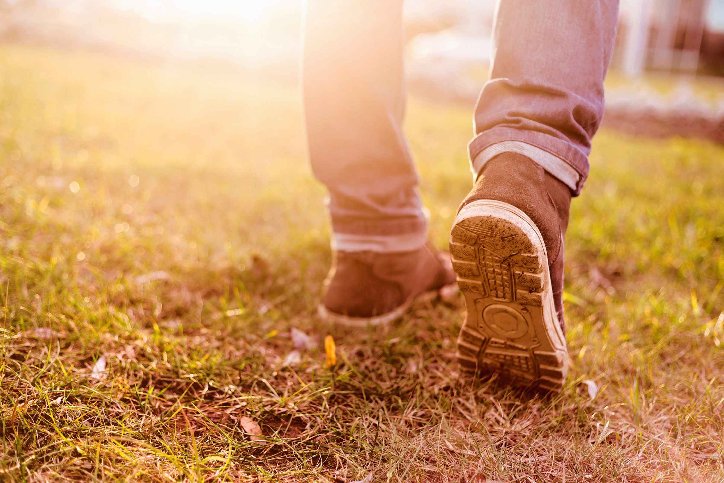 closeup of a person's boots, walking outdoors