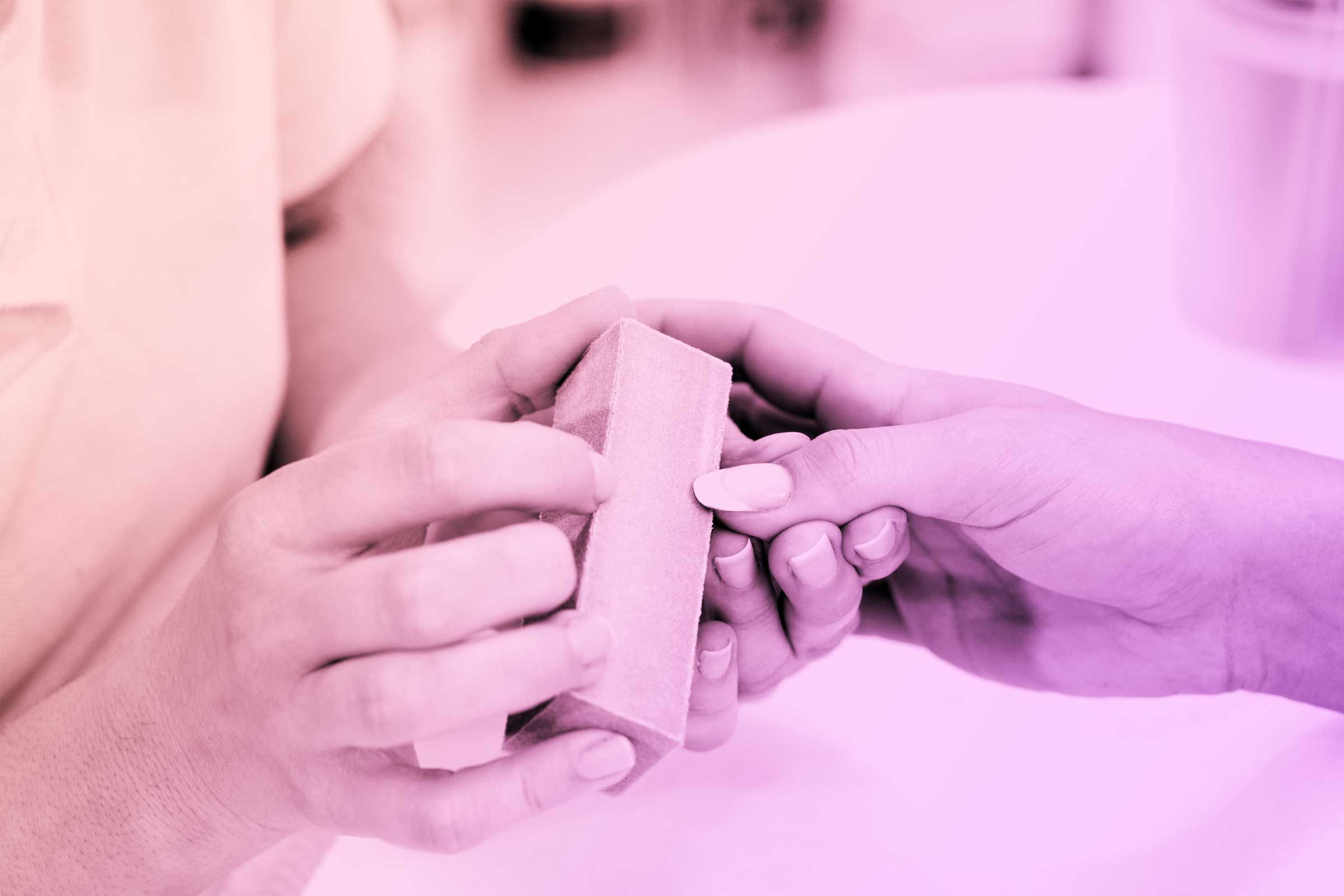 person using emery board on nails