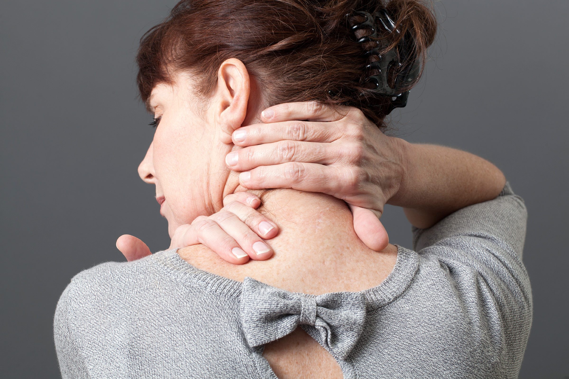 woman massaging her neck 