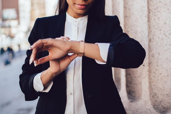 Woman checking the time on her wristwatch.