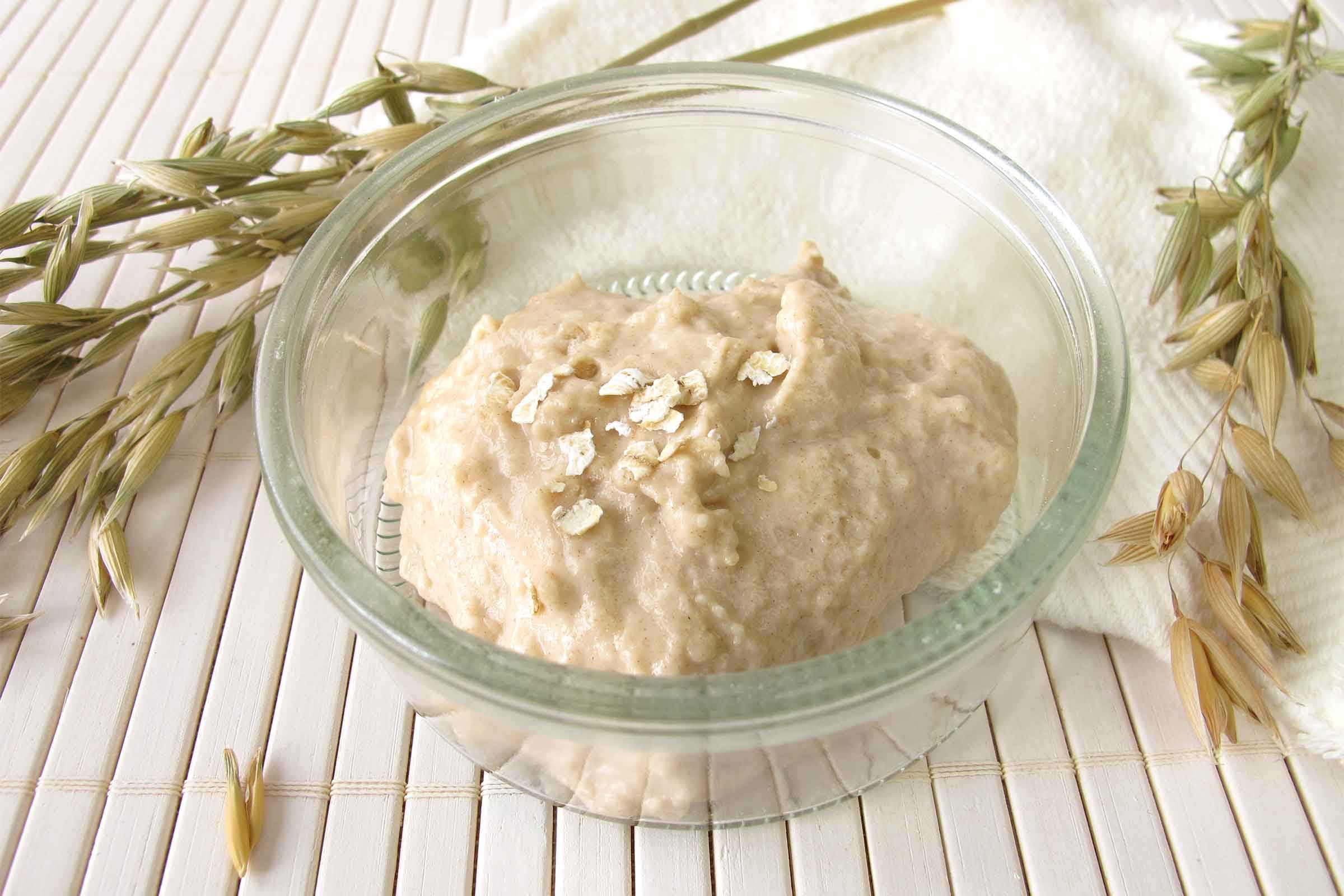 Bowl of cooked oatmeal in a clear bowl.