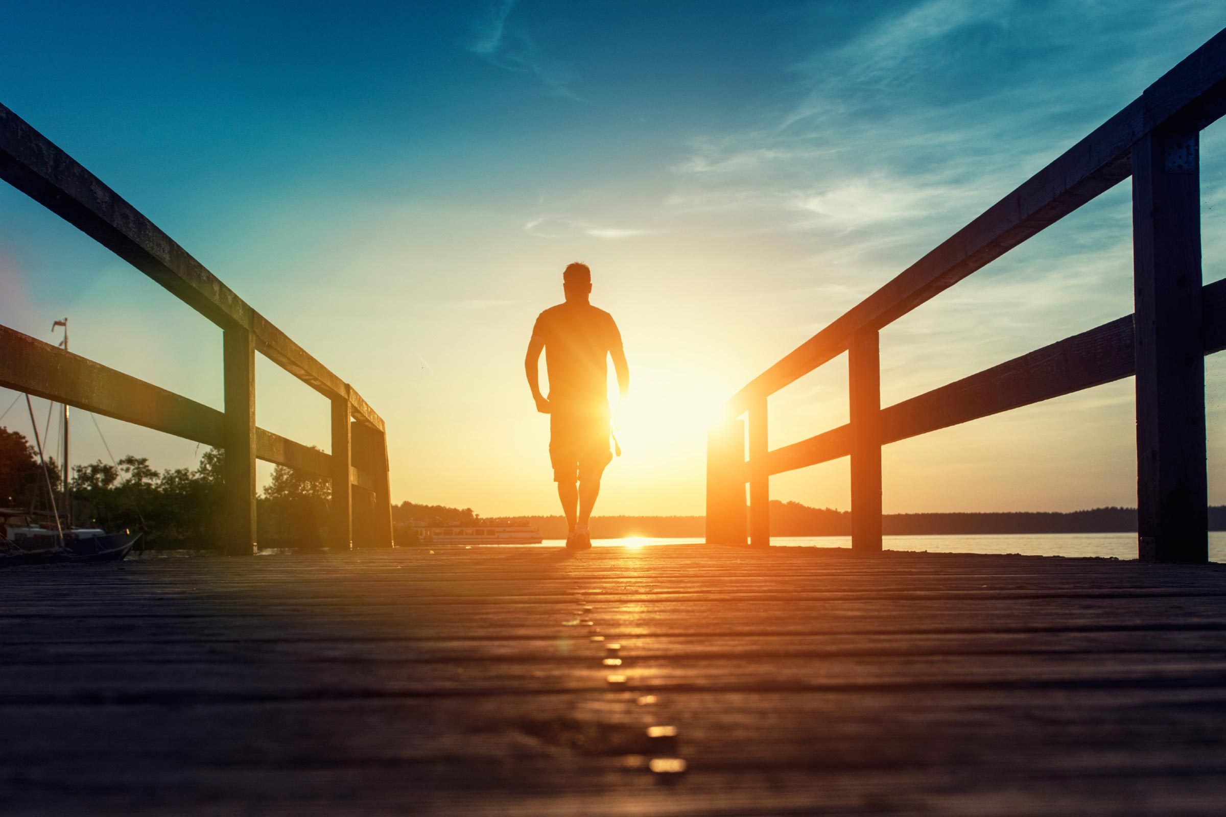 Person walking at sunset