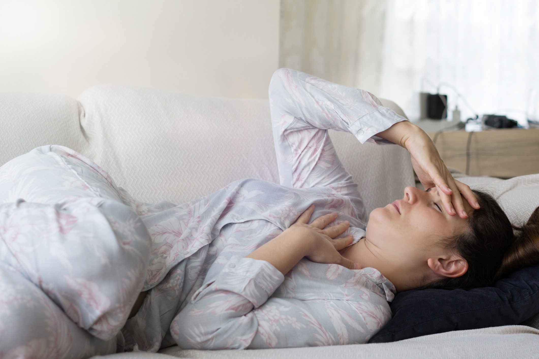 woman laying down with headache