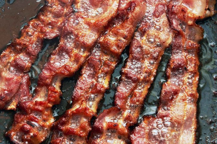 bacon cooking on a grill