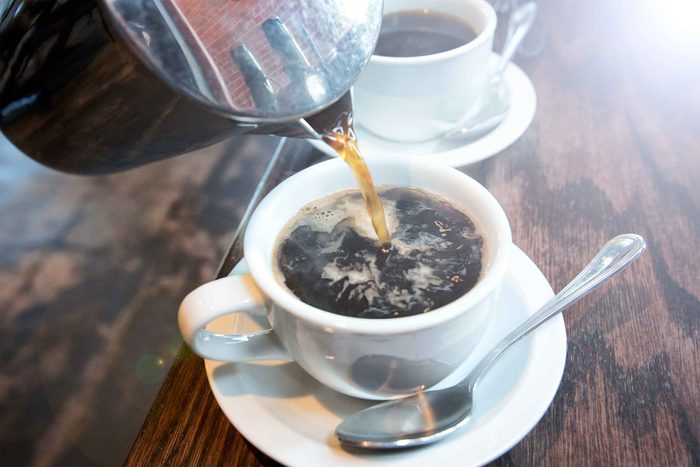 coffee pot pouring coffee into cup