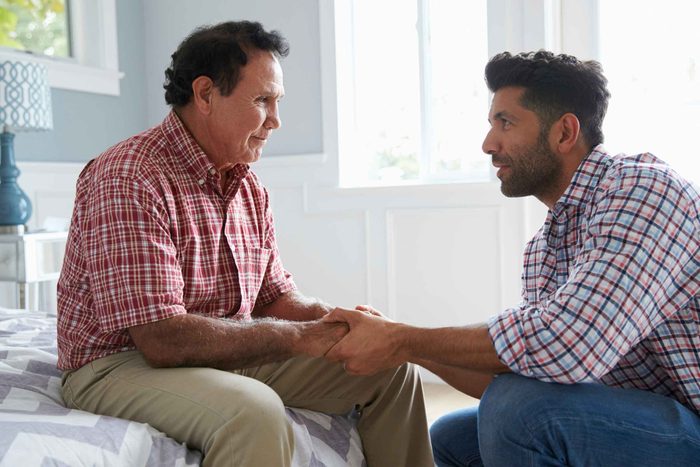 younger man talking to his father